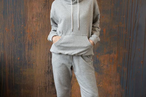 Woman in a balanced standing pose against a simple background.